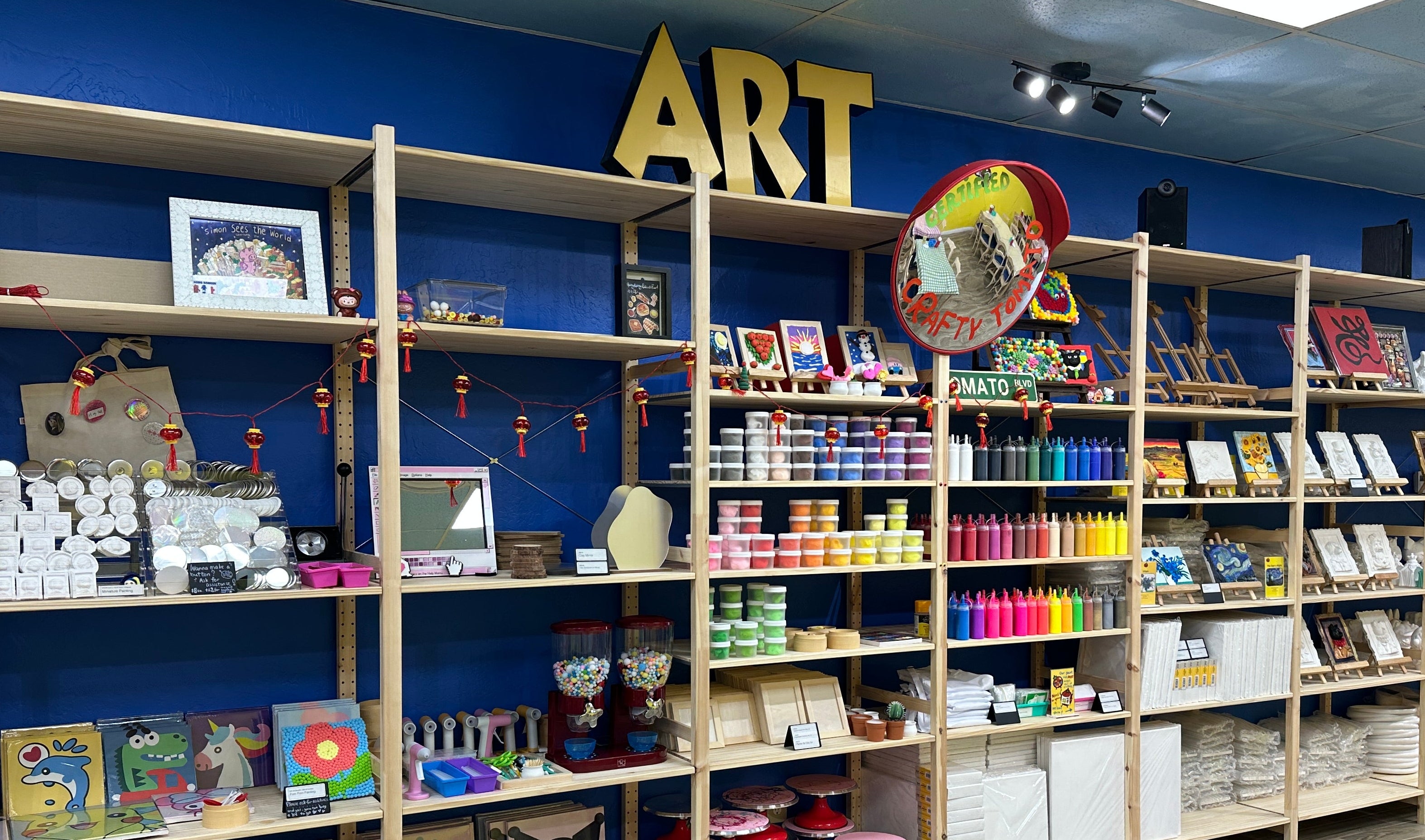 DIY Craft Studio store with shelves filled with books, stationery items, and a 'Art' sign on the wall.