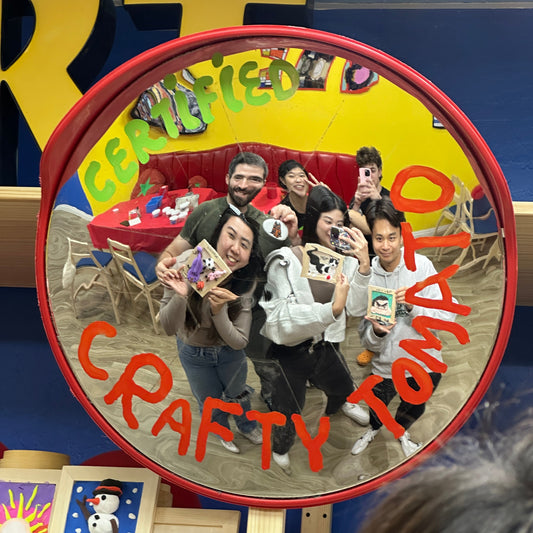 Circular mirror with a collage of people and text 'Old Wood Crafty' on a colorful background