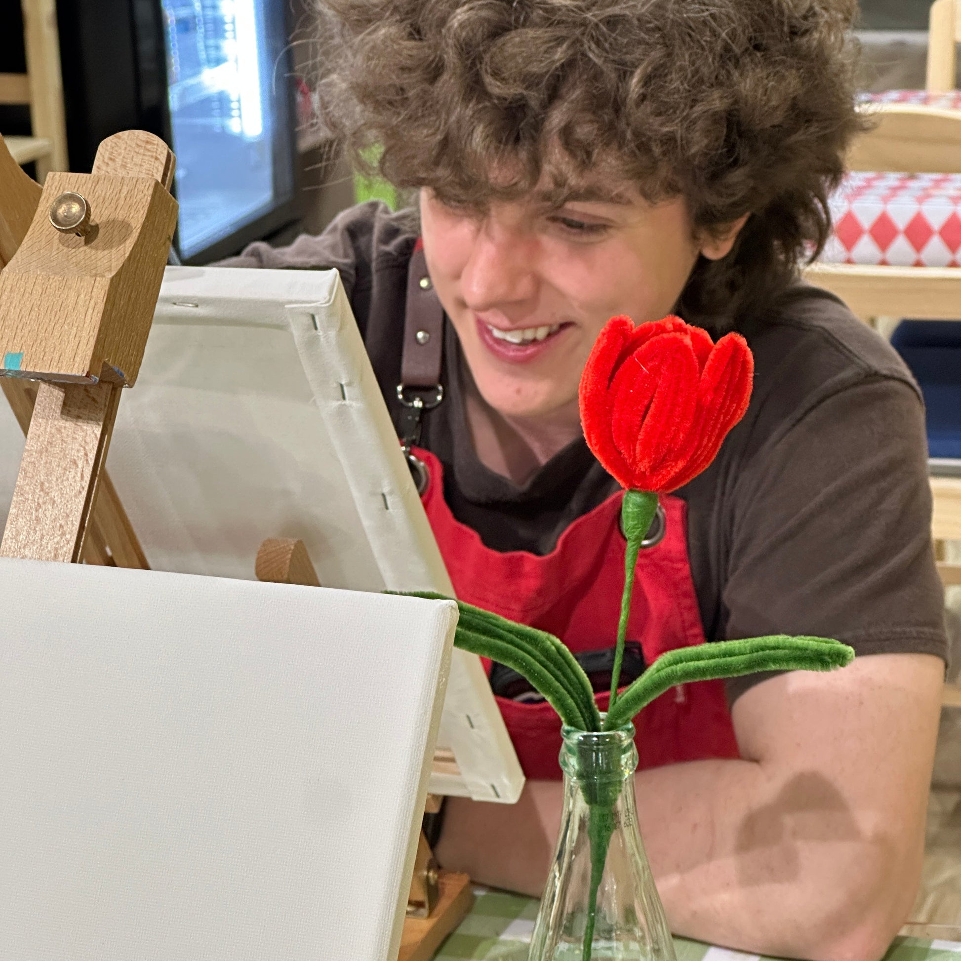 a guy painting his date at Crafty Tomato