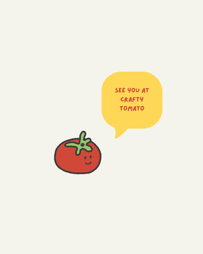 A minimalist graphic print featuring a cute red tomato with a green stem and a yellow speech bubble that reads 'SEE YOU AT CRAFTY TOMATO' on a light cream background.